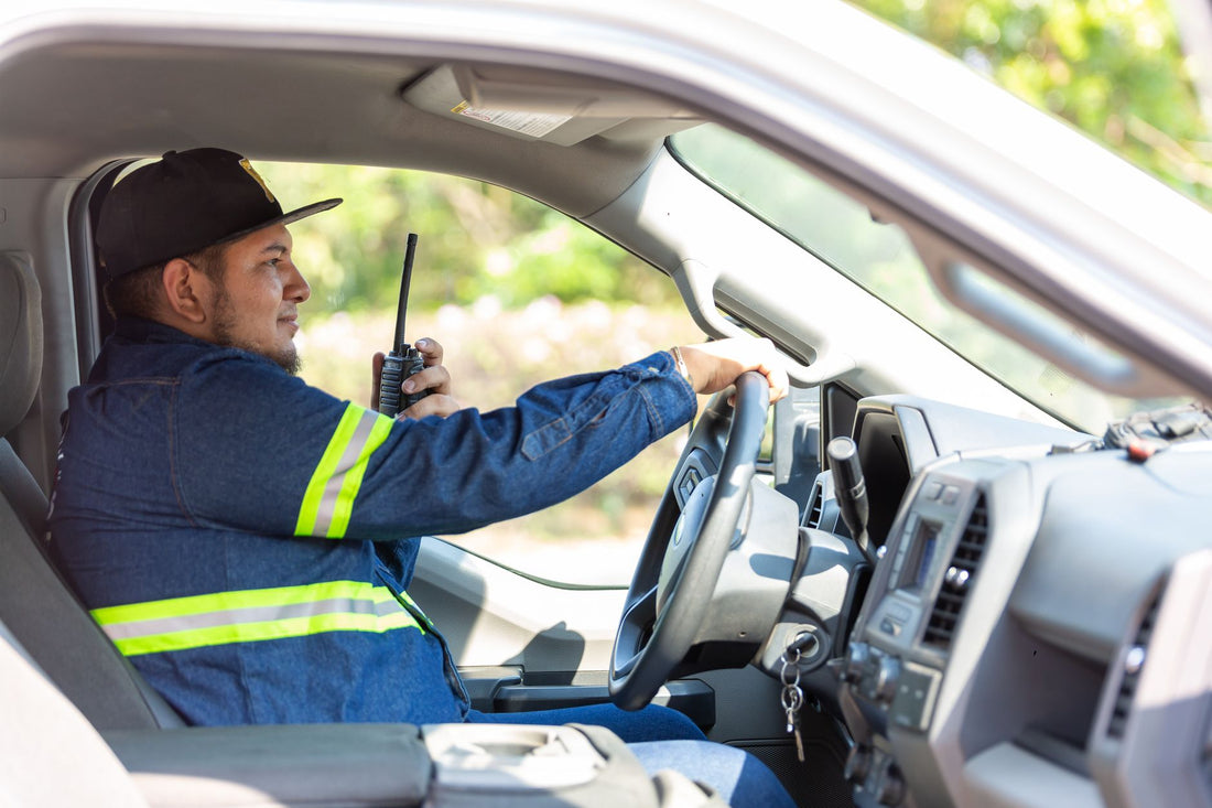 Worker using a push-to-talk two-way radio on the job